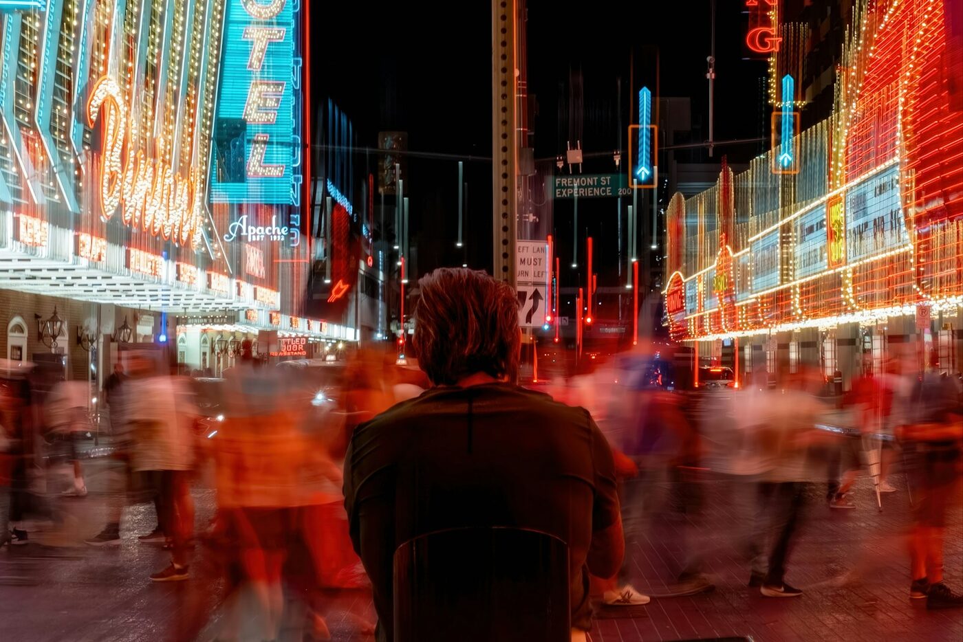 Neon signs and a moving crowd on Fremont Street in Downtown Las Vegas at night